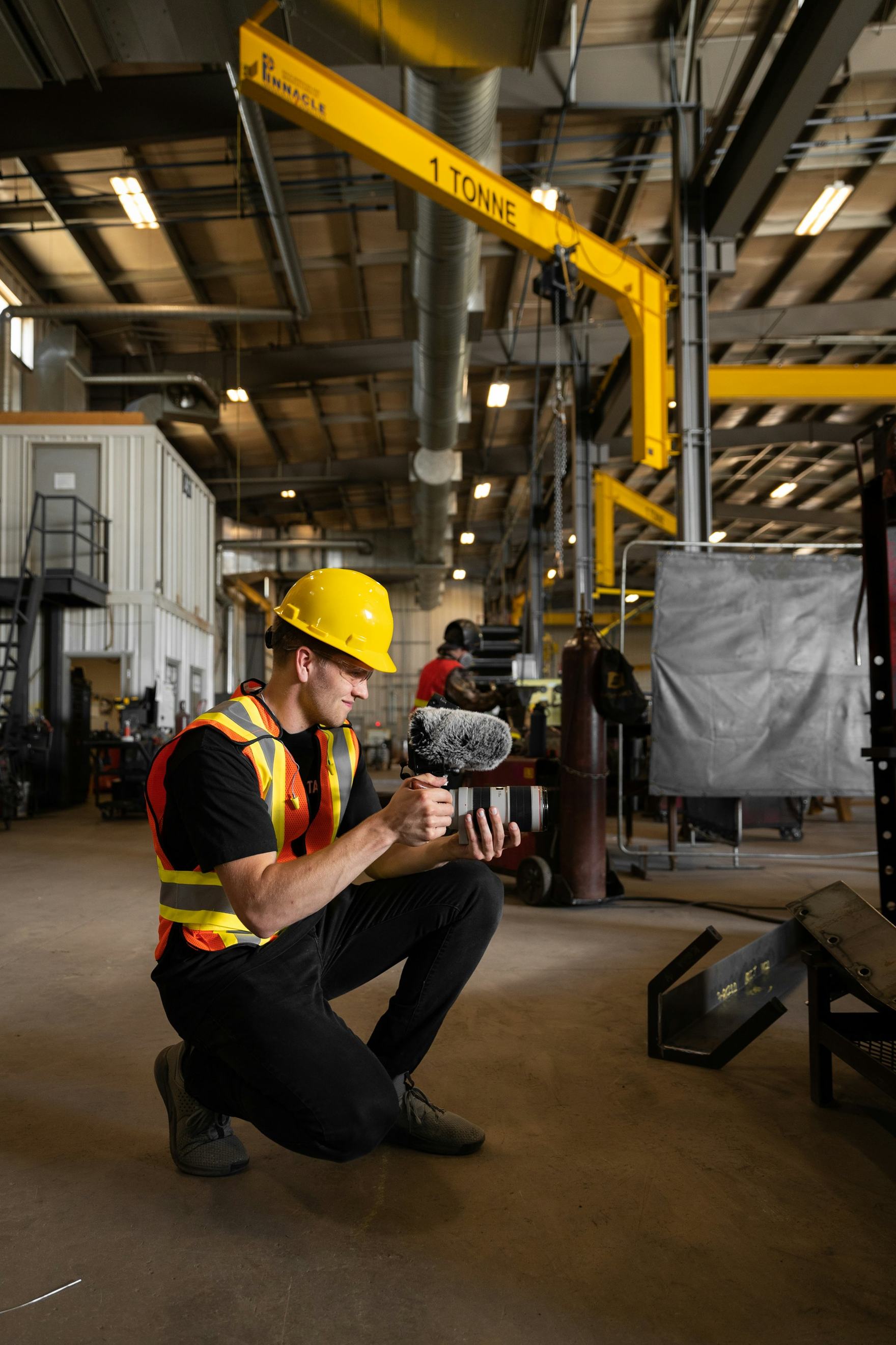 Two technicians reviewing data on a tablet inside an industrial facility